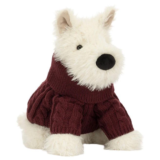 Jellycat knuffelhond Munro Scottie Dog met een donkerrode gebreide wintertrui, schuin van voren gezien.