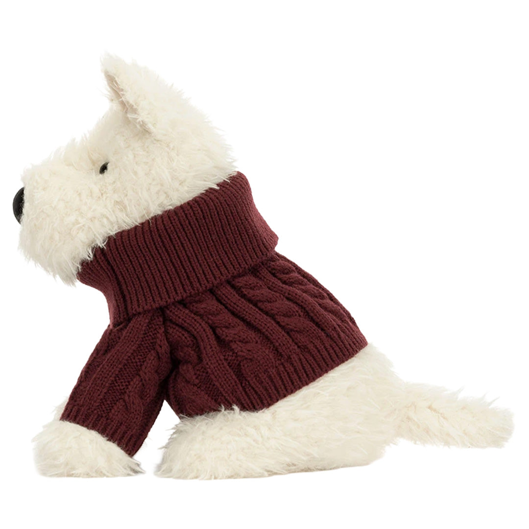 Jellycat knuffelhond Munro Scottie Dog met een donkerrode gebreide wintertrui, van de zijkant gezien.