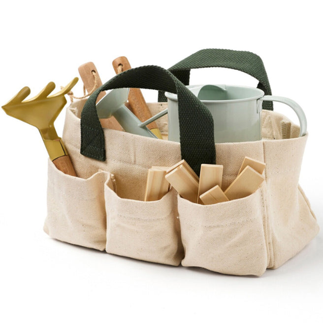Kids Concept tuingereedschapsset in een beige canvas tas met groene handvatten, gevuld met gereedschap en houten plantenstekers.