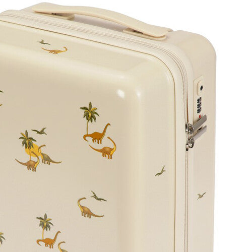 Detail van de beige kinderkoffer met dinosaurus- en palmboomprint en het cijferslot.