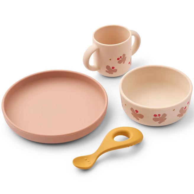 Liewood siliconen kinderservies met roze bord, kom, beker en gele lepel met vlinderpatroon.