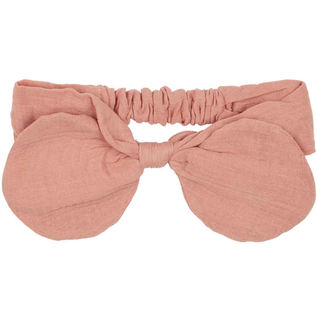 Mimi & Lula roze babyhaarband met grote strik, plat gefotografeerd.
