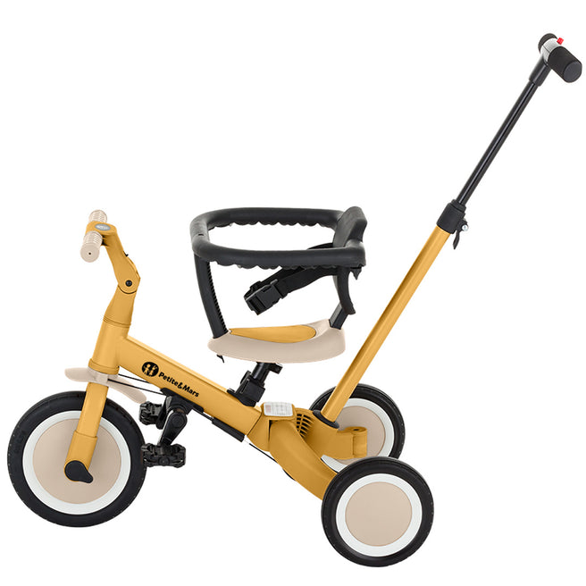 Petite&Mars 5-in-1 kinderfiets in intense ochre als driewieler met duwstang en veiligheidsbeugel.